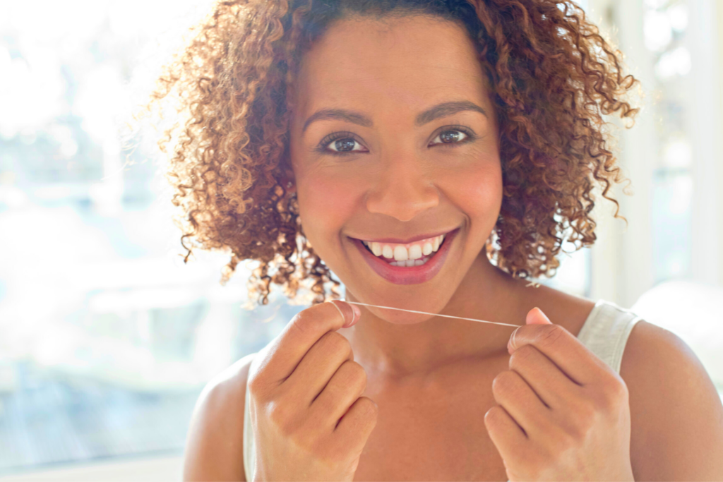 woman flossing her teeth to make them whiter