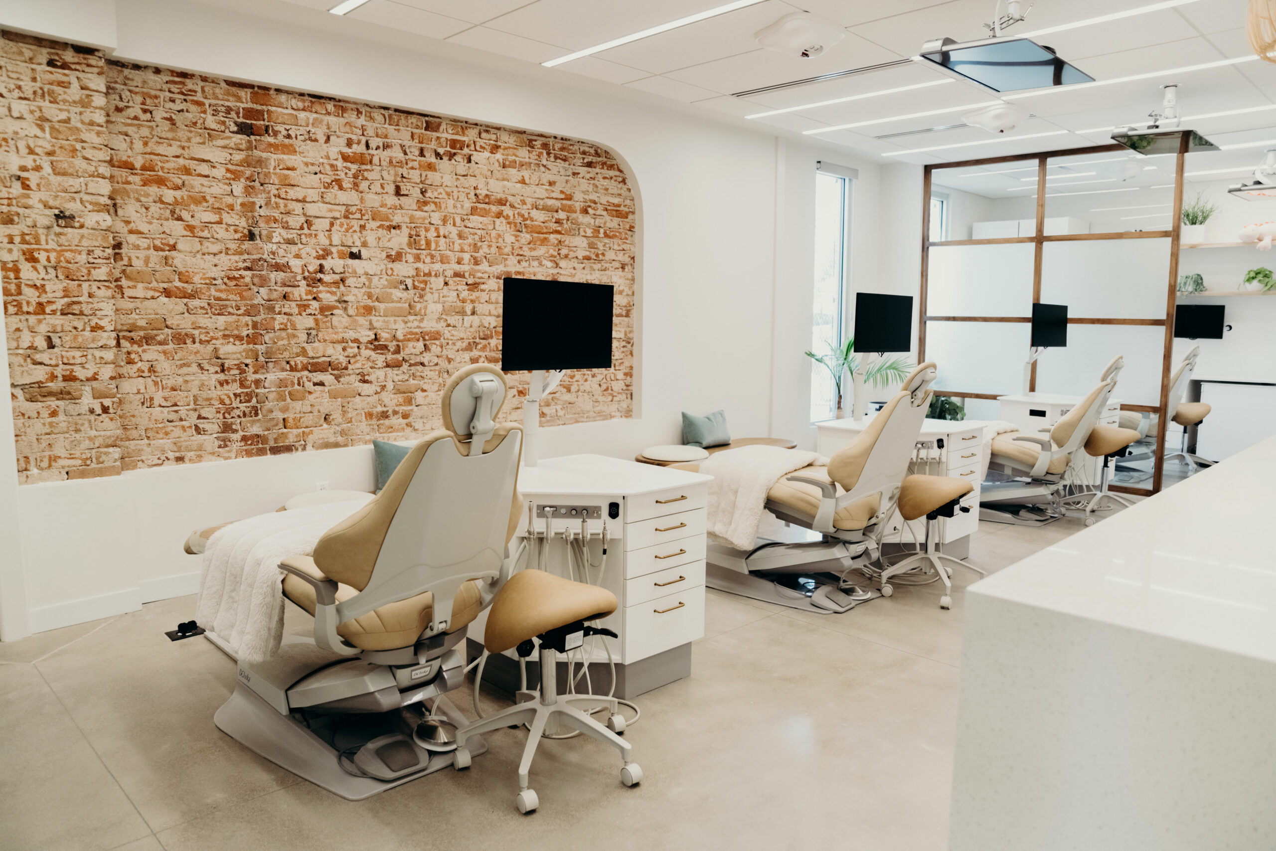 Treatment bay at Aligned Orthodontics, a Denver orthodontist office on South Pearl Street, with exposed brick and natural light