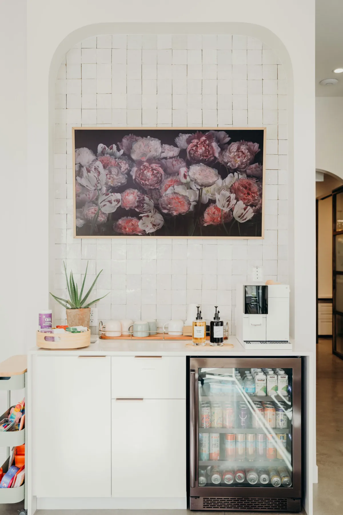 Counter with a drinks fridge and a floral painting at aligned. Orthodontics in Denver