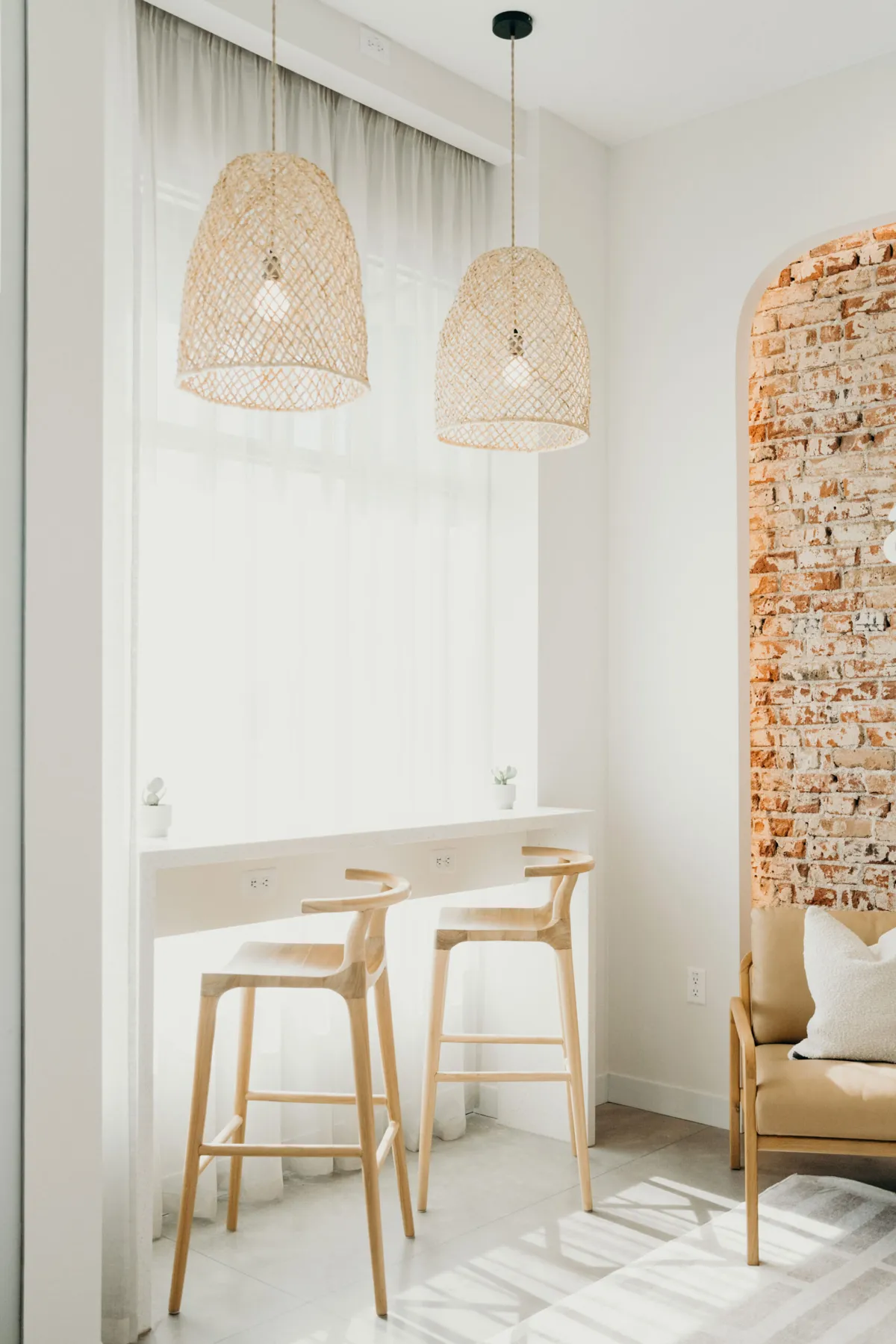 Window counter with stools under woven pendant lights at aligned. Orthodontics in Denver