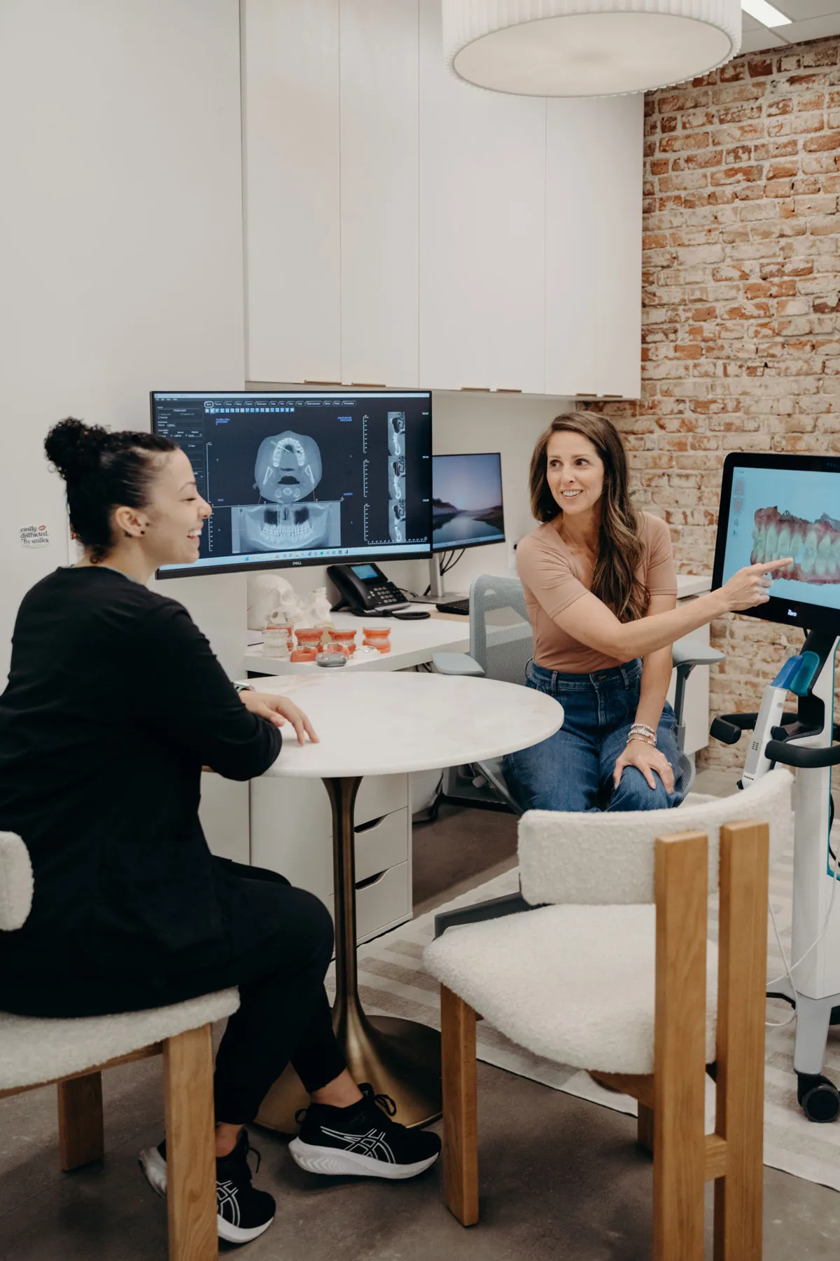 A patient looks at her own 3D teeth scan on a screen during a consultation at aligned. Orthodontics in Denver